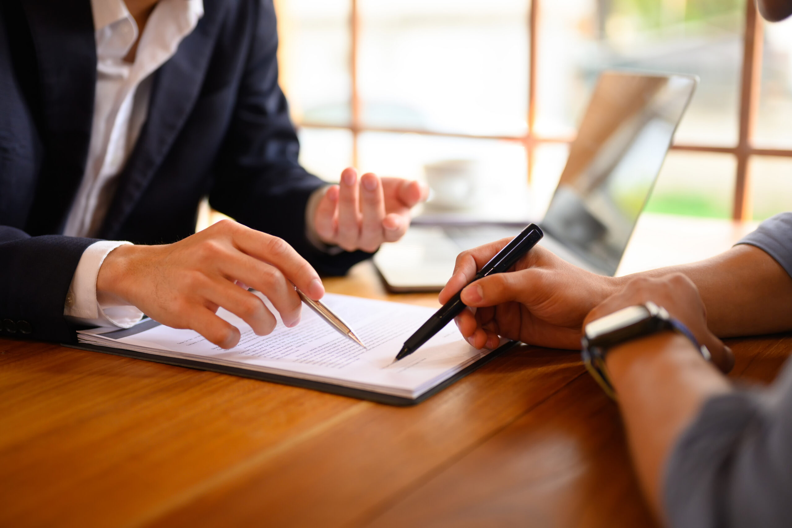 Closeup lawyer or insurance agent pointing at contract